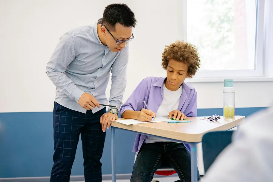 A teacher reviewing paper-based classroom notes